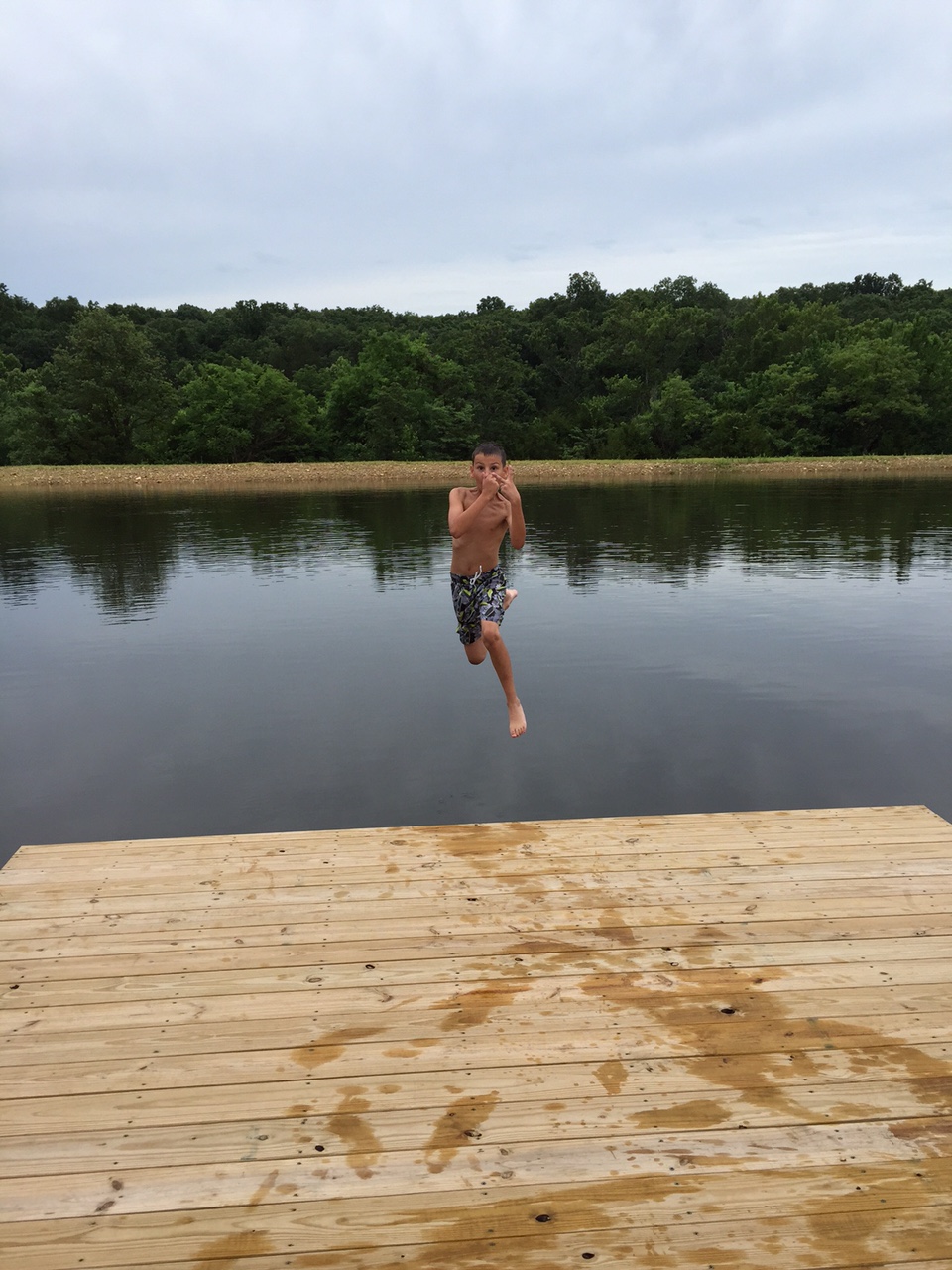 Attached picture June 21 Cole jumping off of dock.jpg